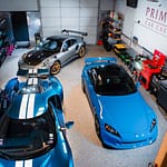 Three sports cars sit in a shop